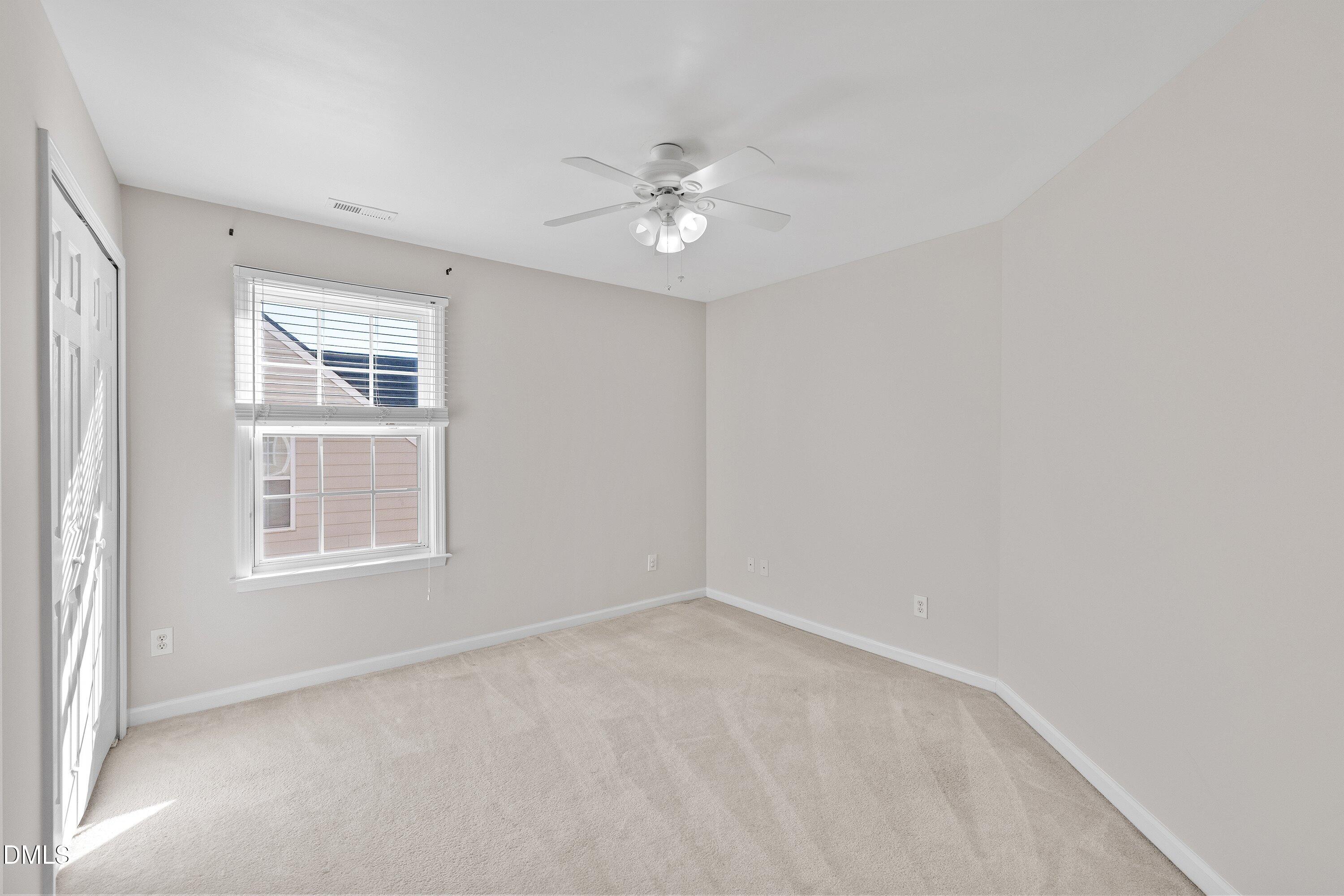 5717 Keowee Way Raleigh, NC 27616 - Photo 25 of 41 an empty room with a window and a fan