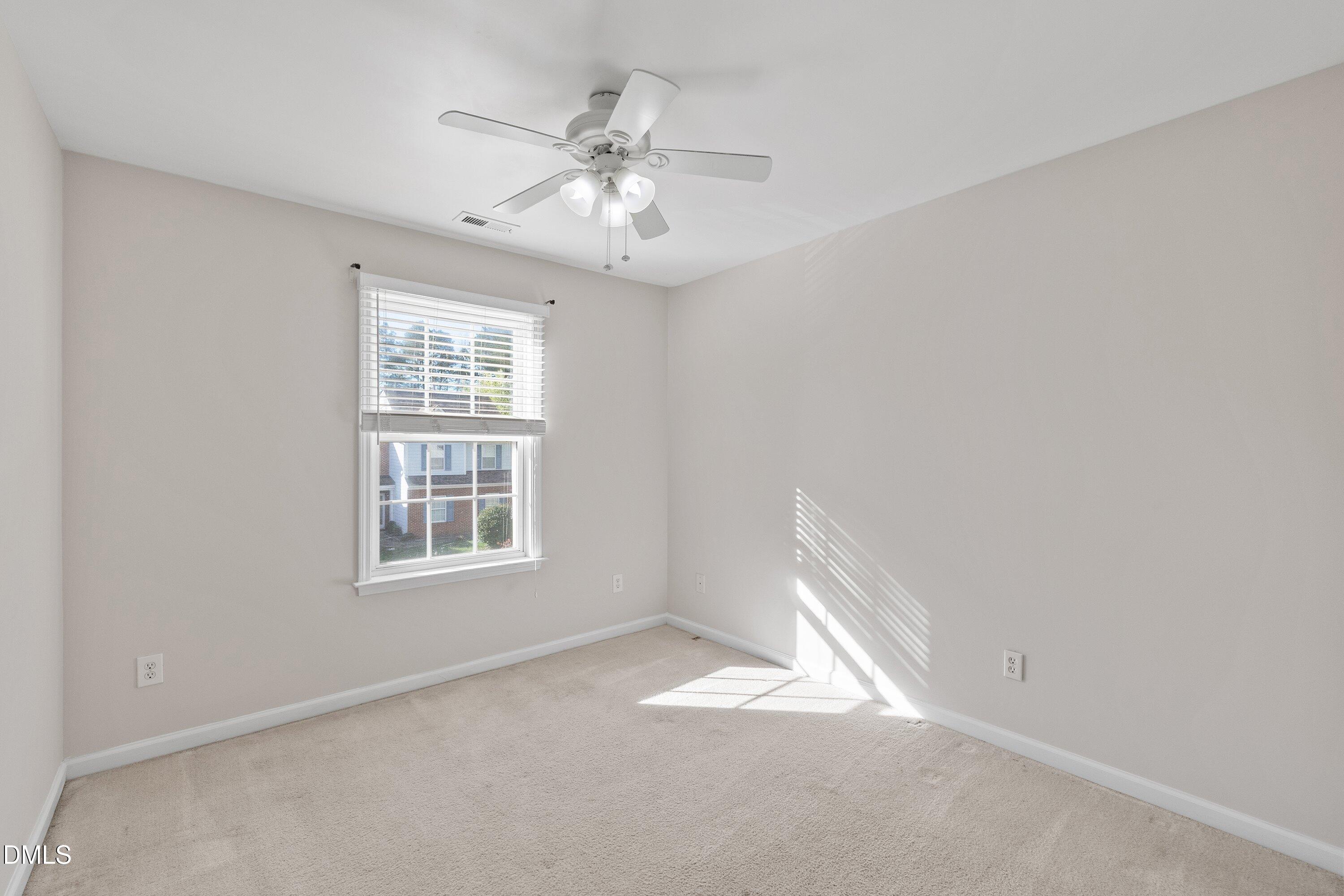 5717 Keowee Way Raleigh, NC 27616 - Photo 29 of 41 an empty room with windows and fan
