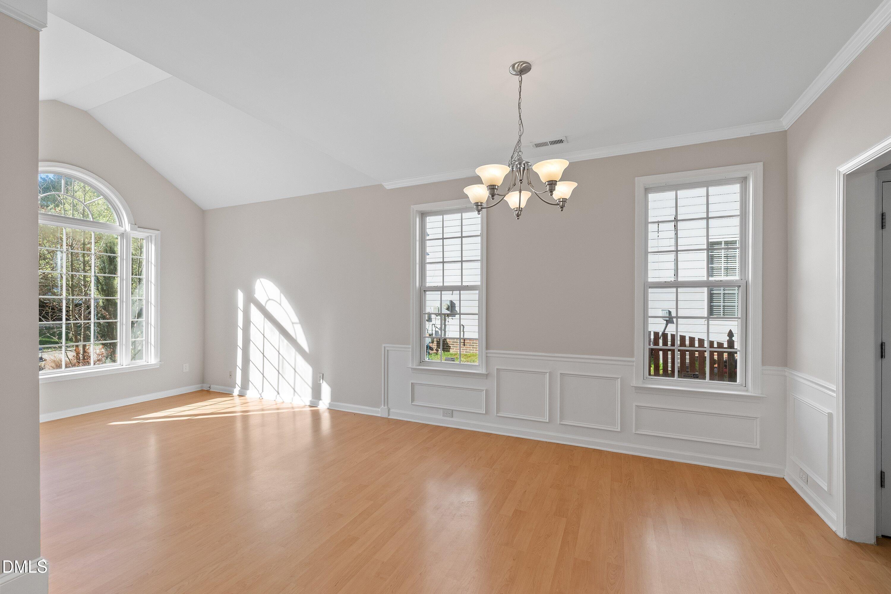 5717 Keowee Way Raleigh, NC 27616 - Photo 3 of 41 a view of an empty room with a window and wooden floor