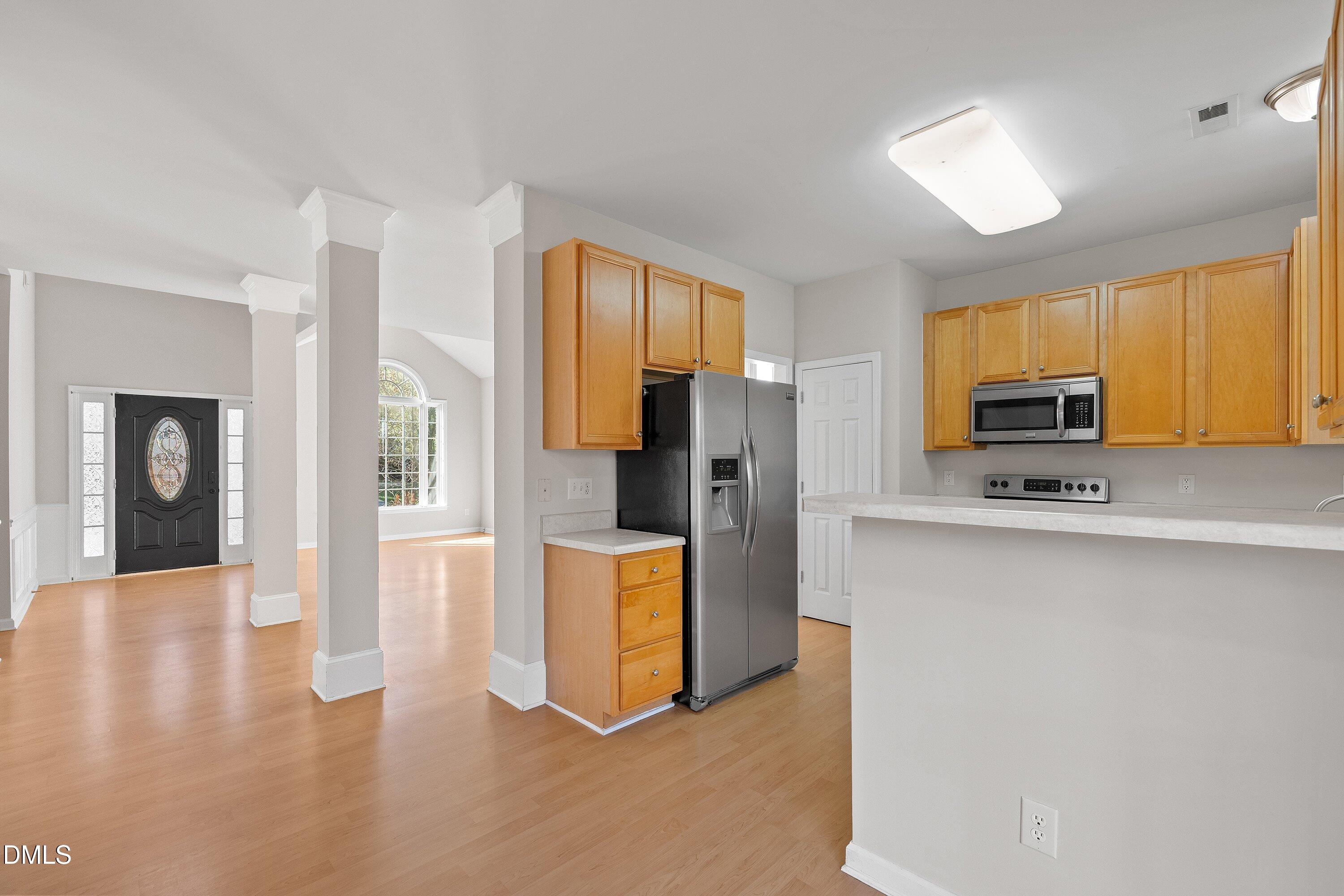 5717 Keowee Way Raleigh, NC 27616 - Photo 7 of 41 a kitchen with stainless steel appliances a refrigerator and microwave