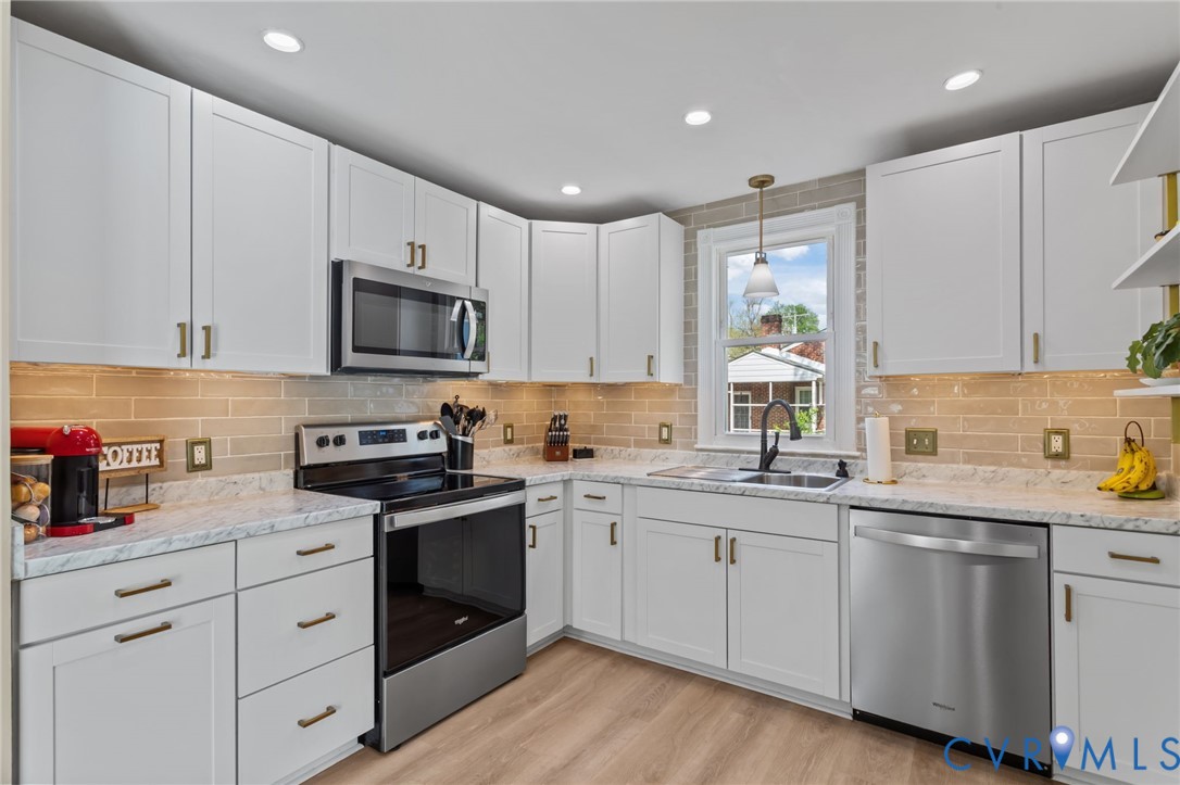 Kitchen with stainless steel appliances, white cab