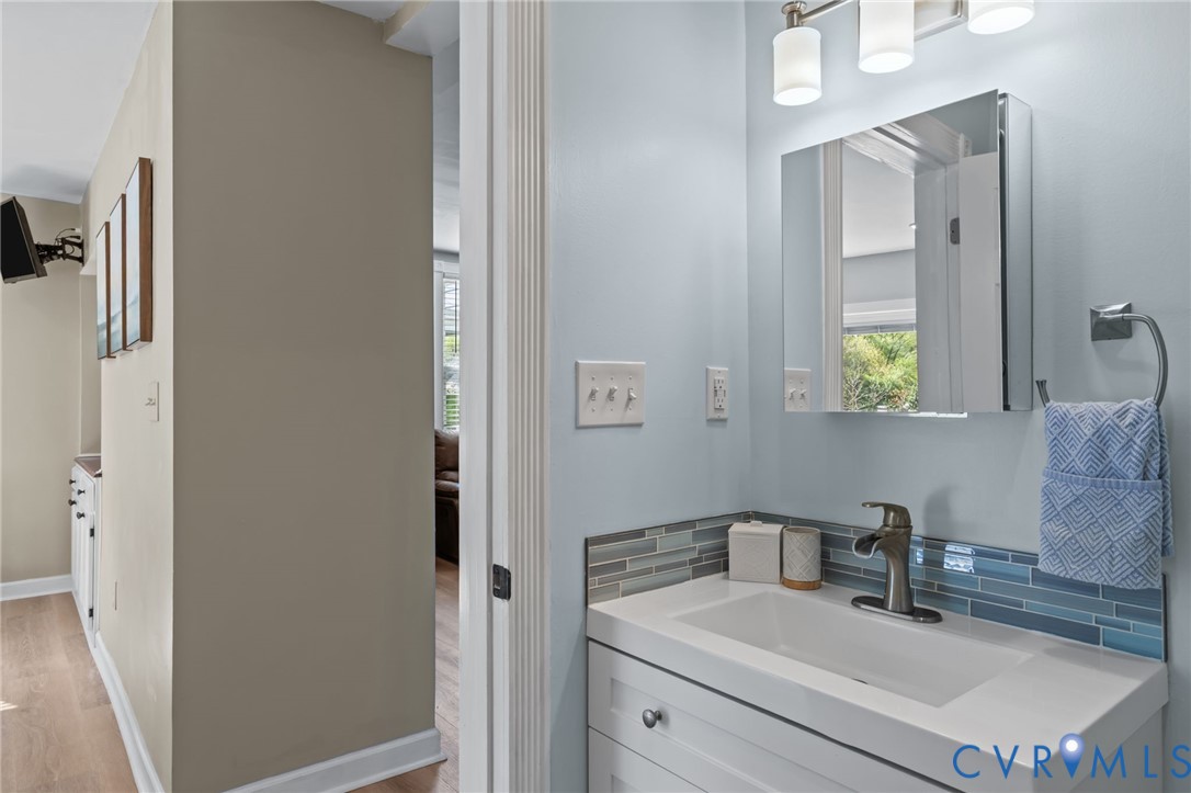6101 River Road Petersburg, VA 23803 - Photo 11 of 37 1st floor half bathroom with vanity, LVP floors, a