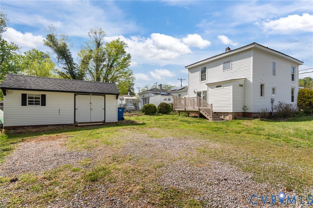 6101 River Road Petersburg, VA 23803 - Photo 34 of 37 Rear view of house featuring a shed, a lawn, and a