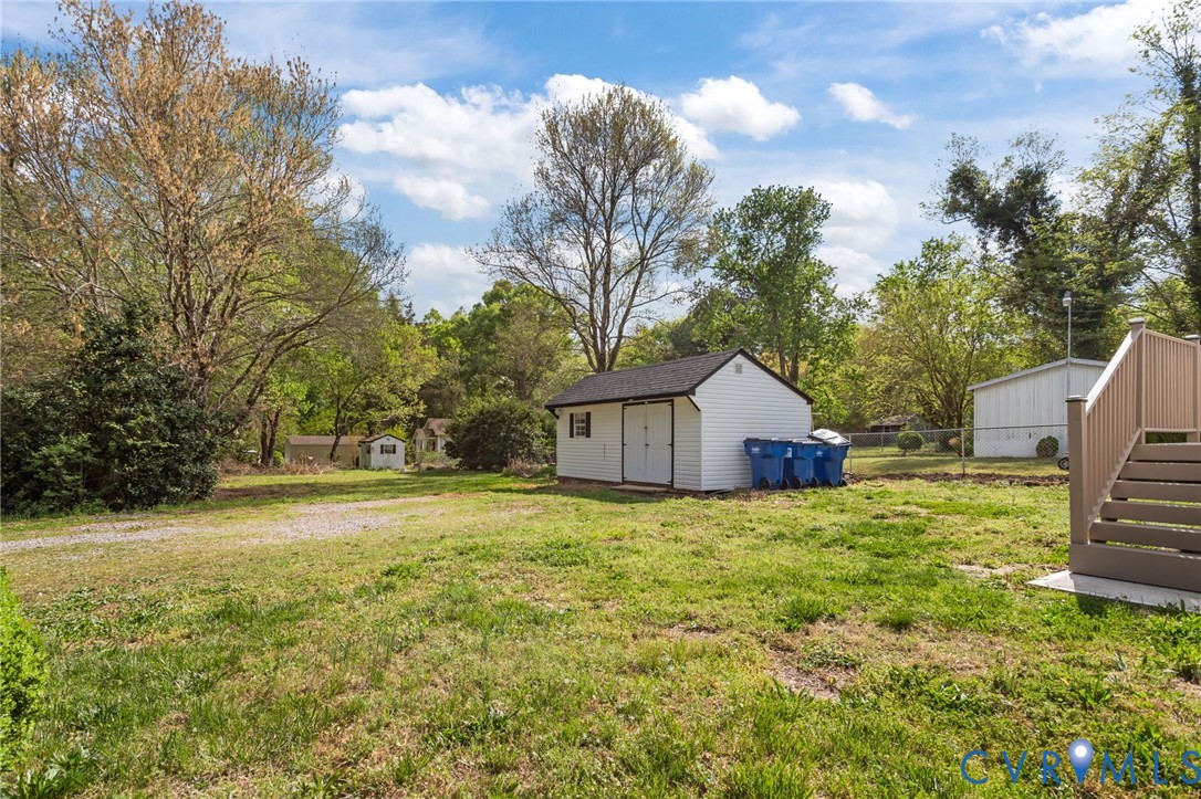6101 River Road Petersburg, VA 23803 - Photo 35 of 37 View of yard with a storage unit and view of trees