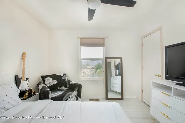 a bedroom with bed and tv