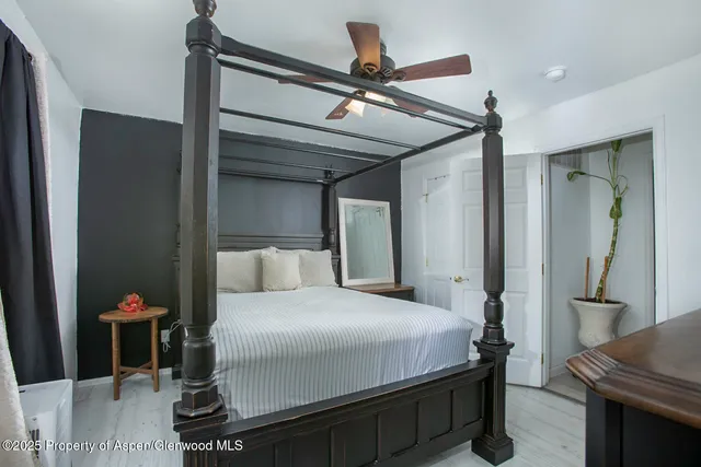 a bedroom with a bed and a mirror