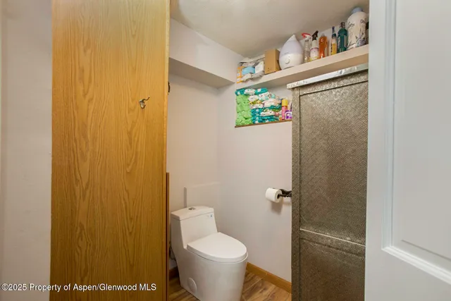 a white toilet sitting next to a bathroom sink and vanity