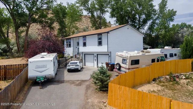 a view of a patio with table and chairs under an umbrella