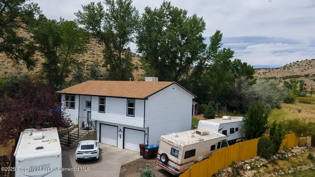 a aerial view of a house with balcony and trees