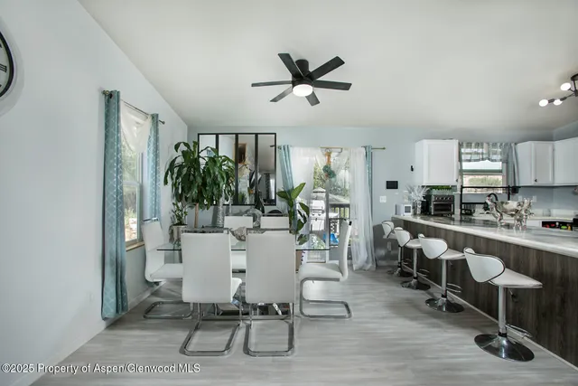 a view of a dining room with furniture window and wooden floor
