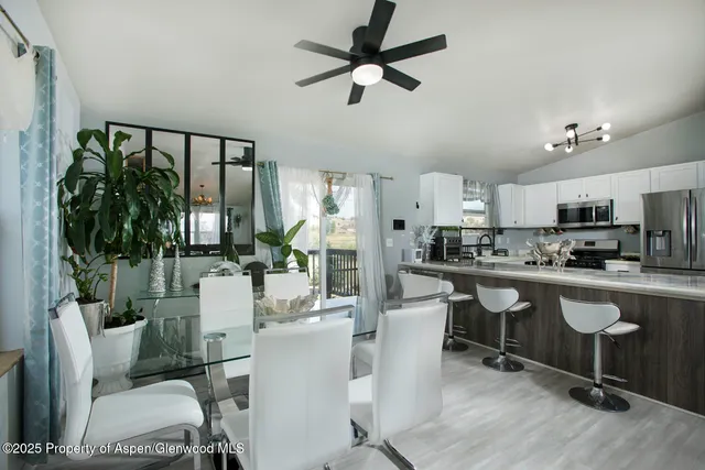 a living room with stainless steel appliances kitchen island granite countertop furniture and a kitchen view
