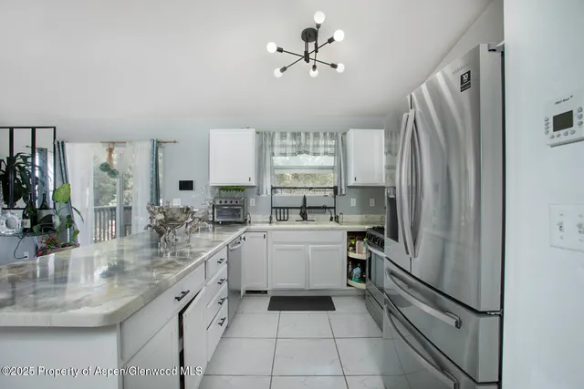 a kitchen with a refrigerator and a sink