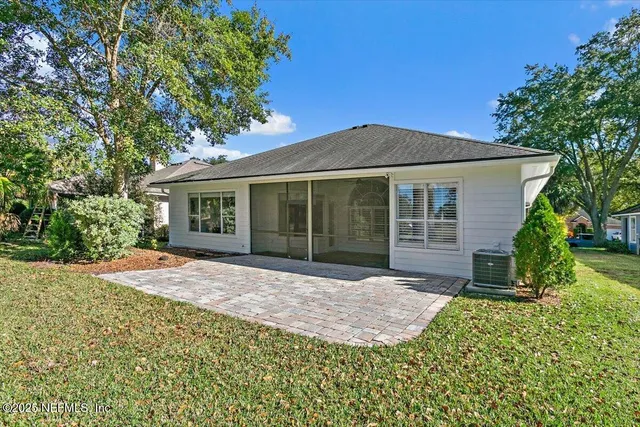 a front view of a house with a garden and yard