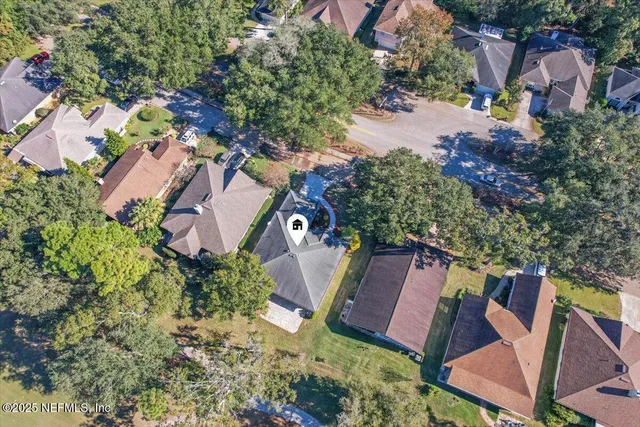 an aerial view of a house with a yard and lake view