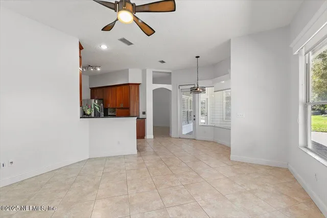a view of a livingroom with a ceiling fan and window