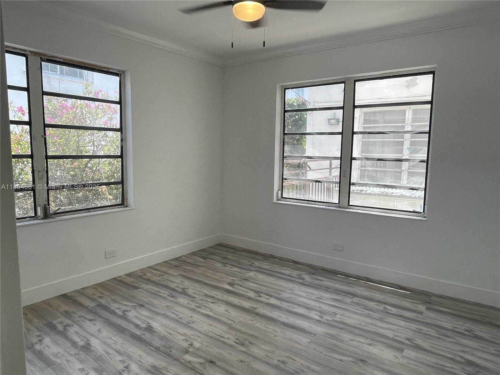 730 12th Street, Unit 10 Miami Beach, FL 33139 - Photo 7 of 12 an empty room with windows