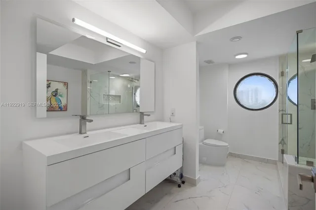 a bathroom with a toilet a sink and a mirror