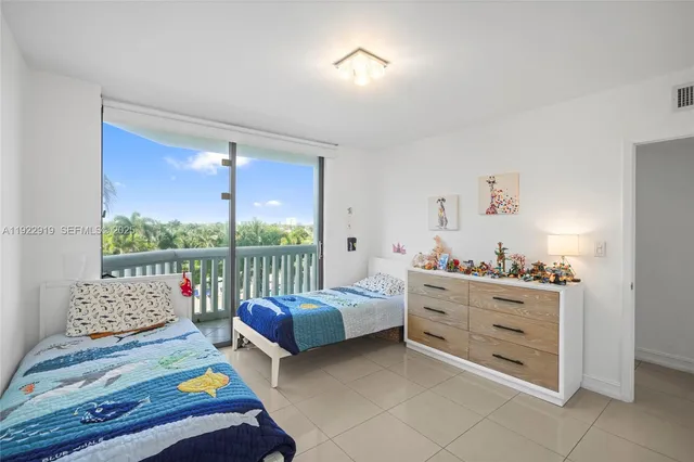 a bedroom with furniture and a large window