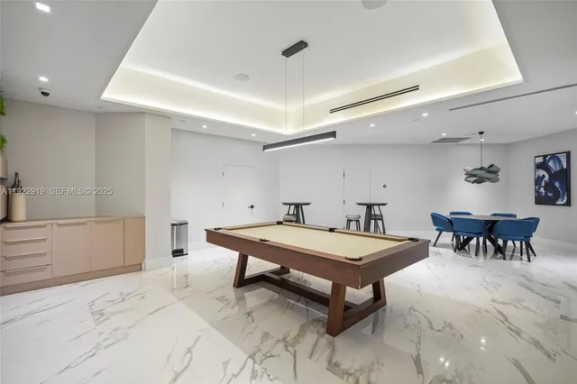 a room with furniture and pool table