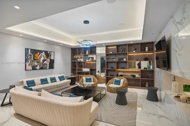 a living room with lots of furniture and clutter