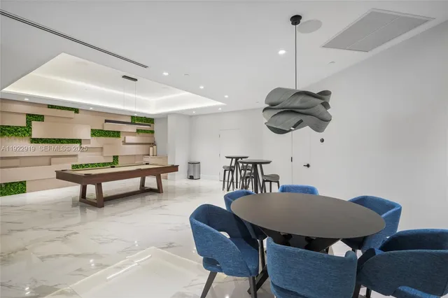 a dining room with furniture and a rug