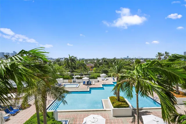 a aerial view of a residential houses with outdoor space and lake view