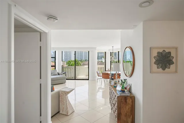 a living room with furniture a lamp and a large window