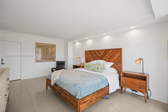 a bedroom with a bed and lamp