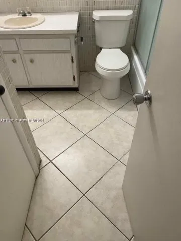 a white toilet sitting next to a bathroom sink