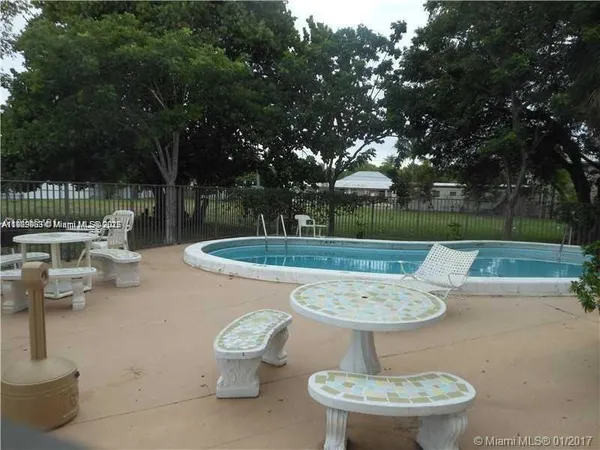 a backyard of a house with yard fountain and outdoor seating