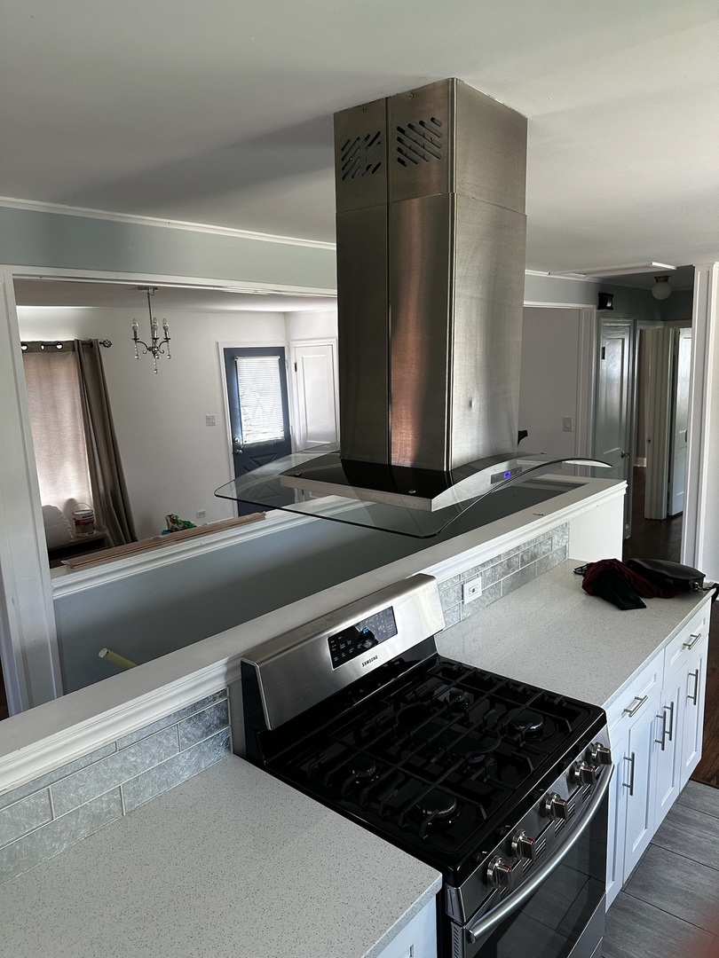 1115 West Roosevelt Road Wheaton, IL 60187 - Photo 6 of 18 a kitchen with stainless steel appliances a sink stove and refrigerator