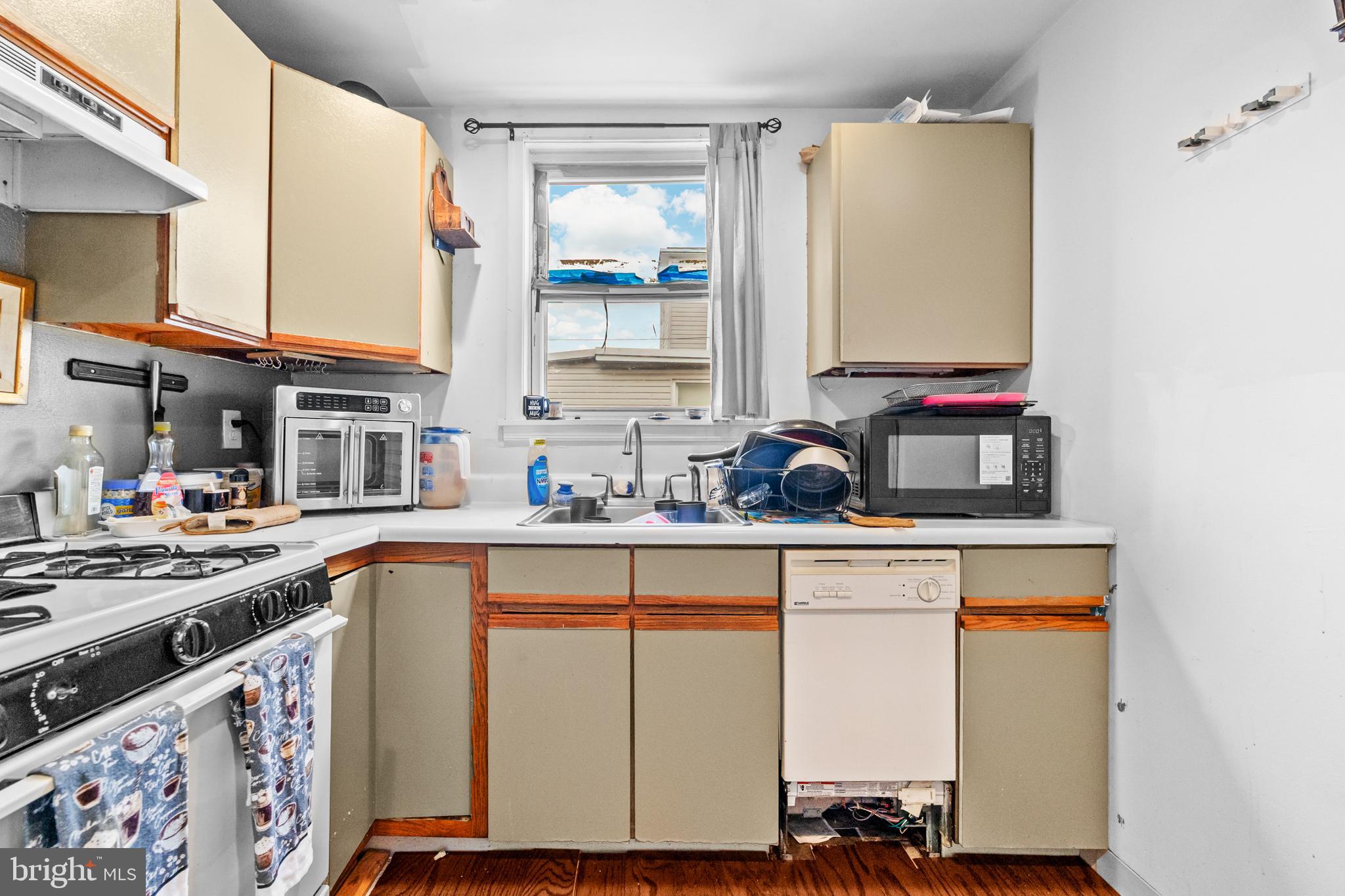 7333-35 Rising Sun Avenue Philadelphia, PA 19111 - Photo 13 of 28 a kitchen with stainless steel appliances granite countertop a stove a sink and a microwave