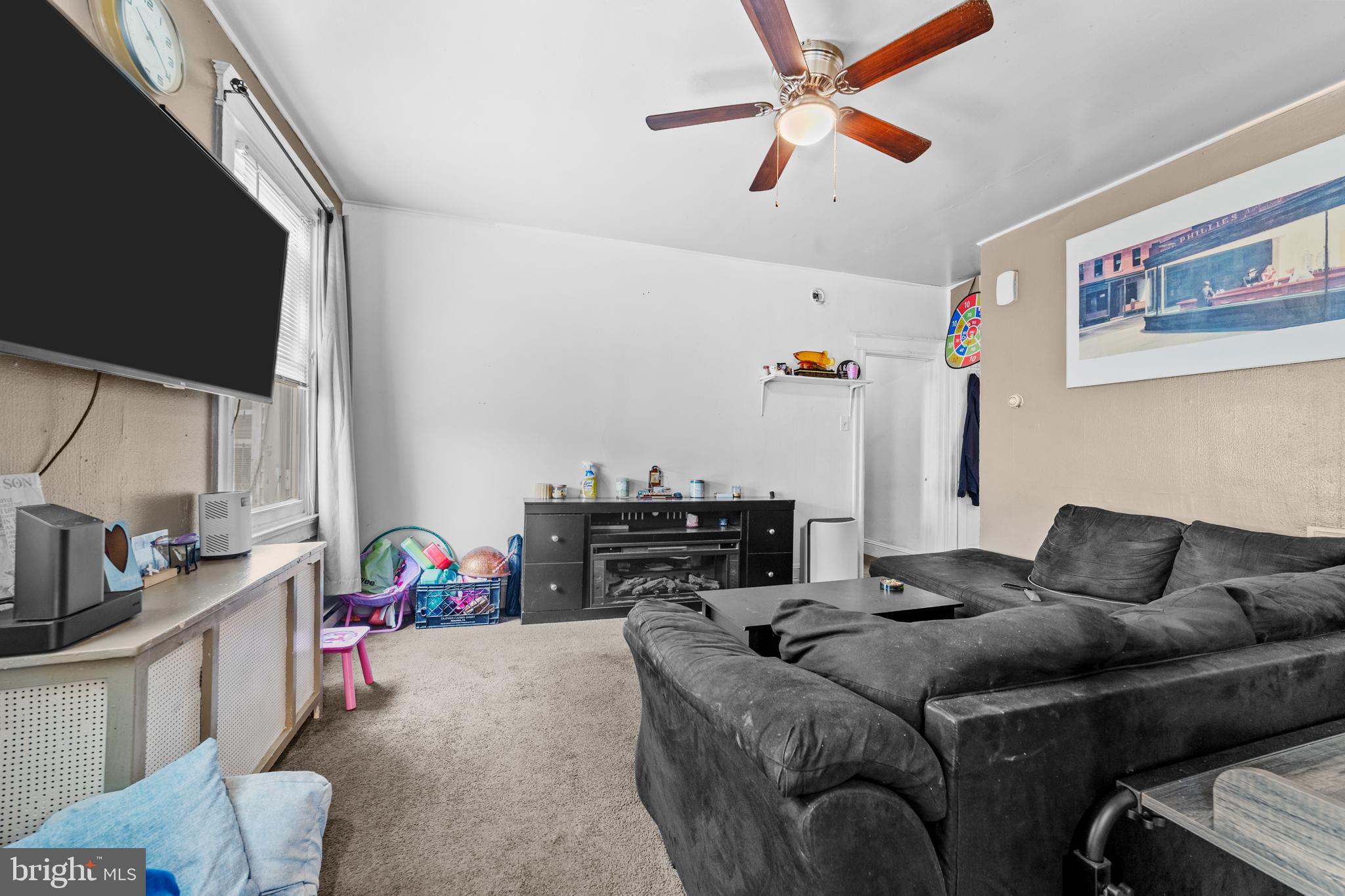 7333-35 Rising Sun Avenue Philadelphia, PA 19111 - Photo 16 of 28 a bedroom with a bed dresser and a flat tv screen