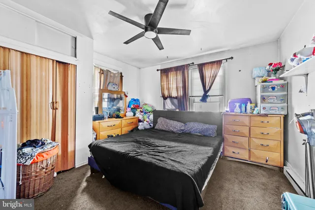 a bedroom with a bed closet and a window