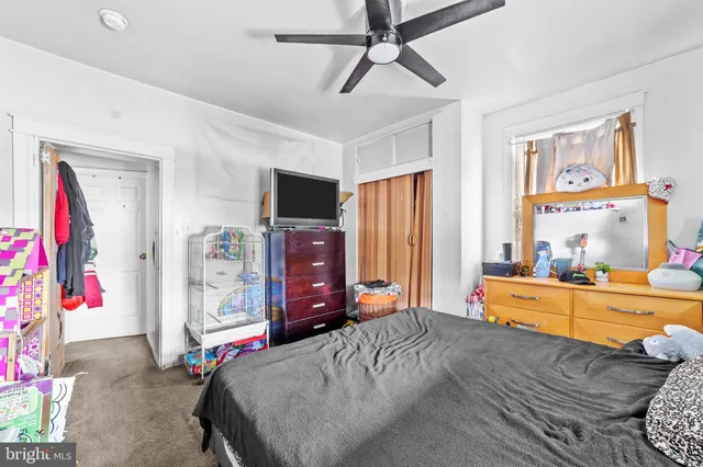 a bed room with a bed and a television