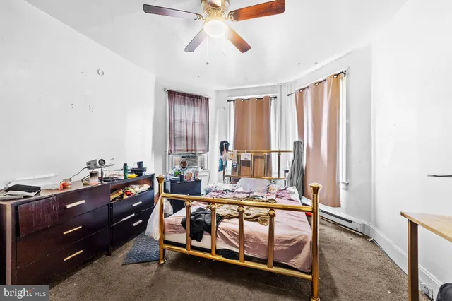 a bed room with furniture and window