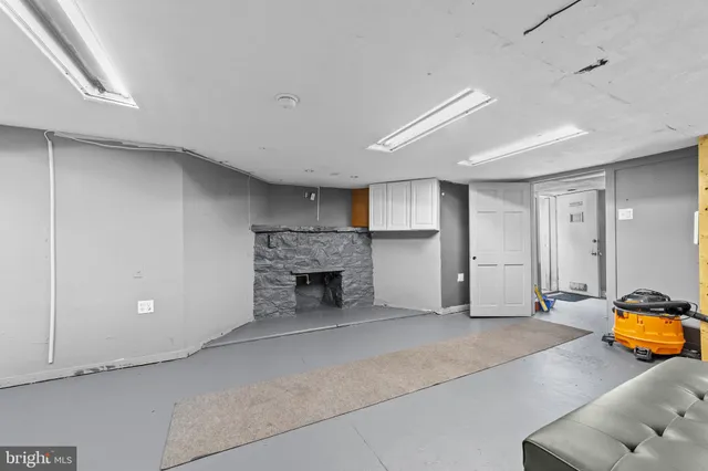 a view of empty room with a fireplace and workspace