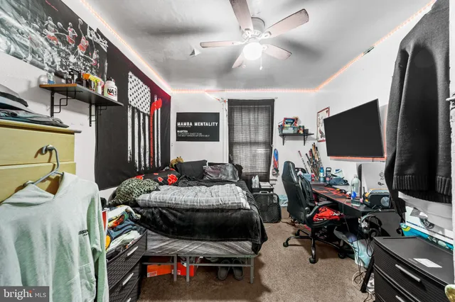 a bedroom with bed a flat tv screen and a walk in closet