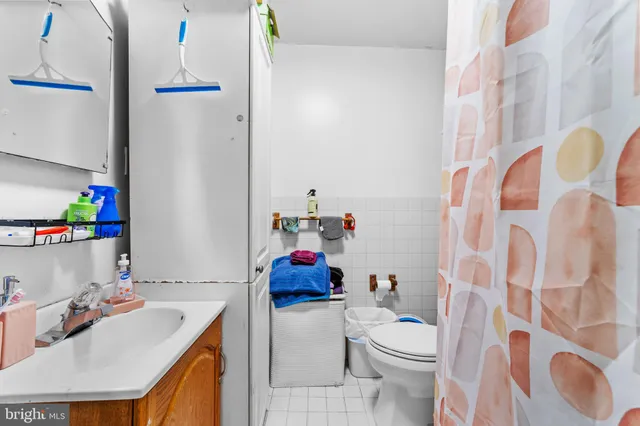 a bathroom with a sink vanity mirror and toilet