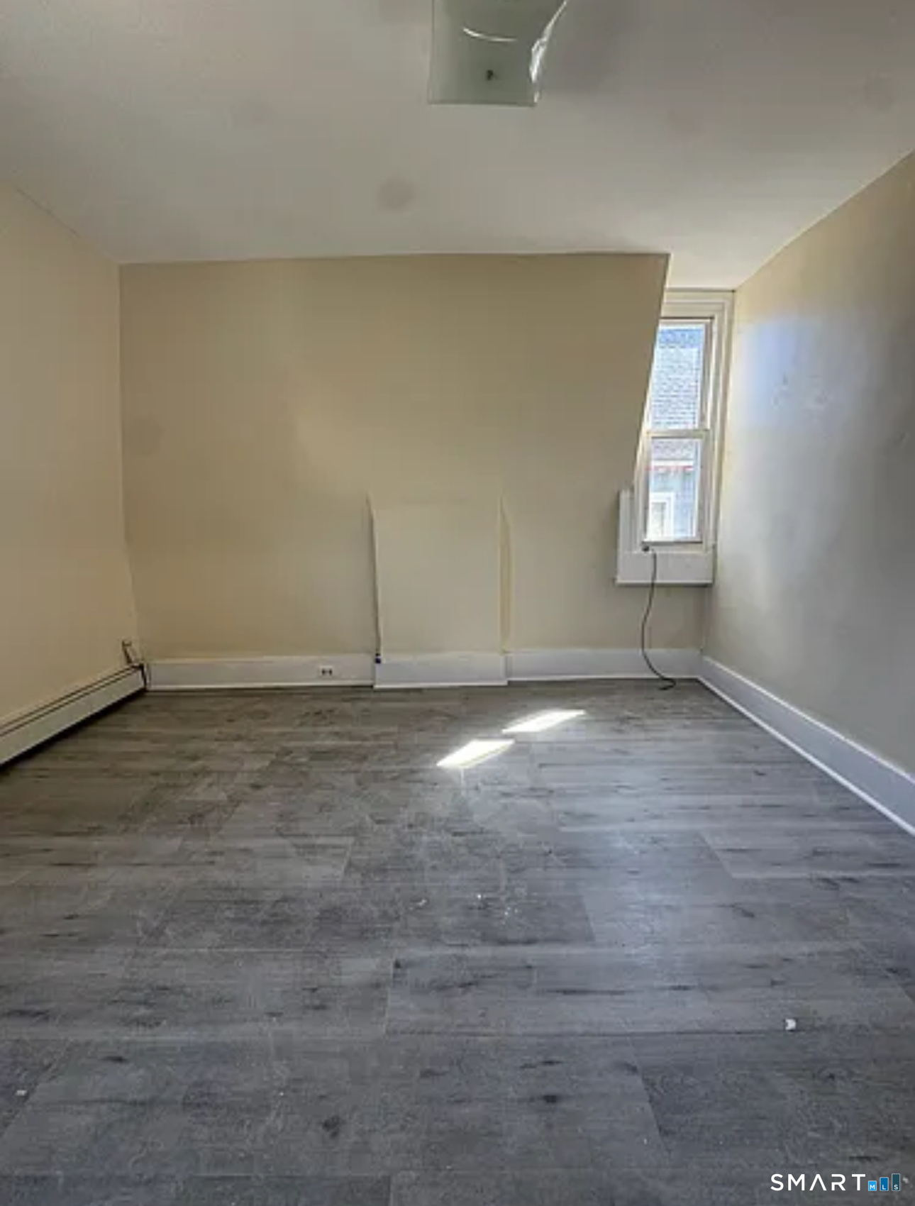 35 Cliff Street Norwich, CT 06360 - Photo 13 of 21 an empty room with wooden floor and windows