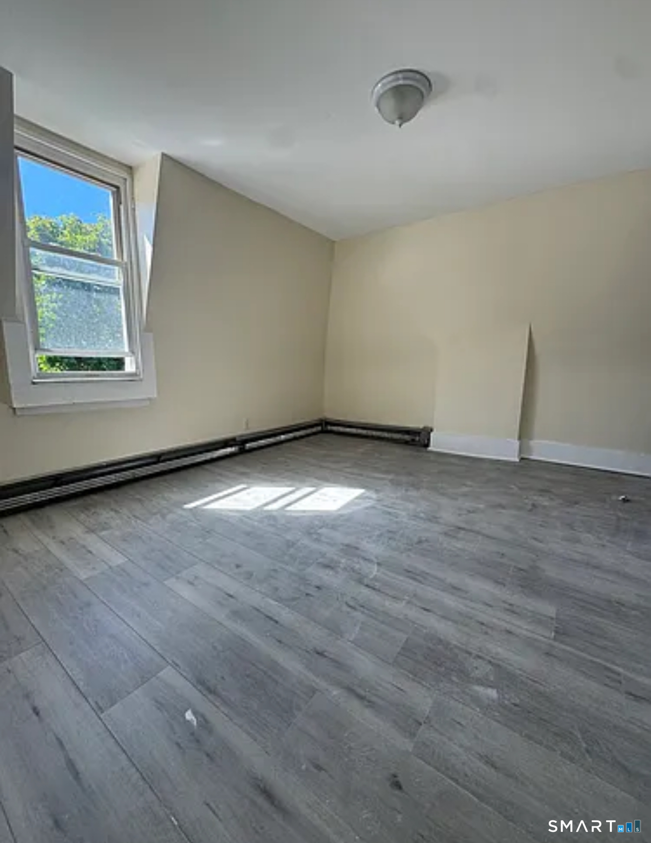 35 Cliff Street Norwich, CT 06360 - Photo 14 of 21 a view of an empty room with wooden floor and a window