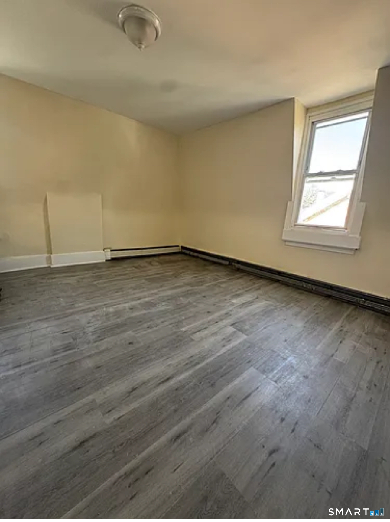 35 Cliff Street Norwich, CT 06360 - Photo 2 of 21 an empty room with wooden floor and windows