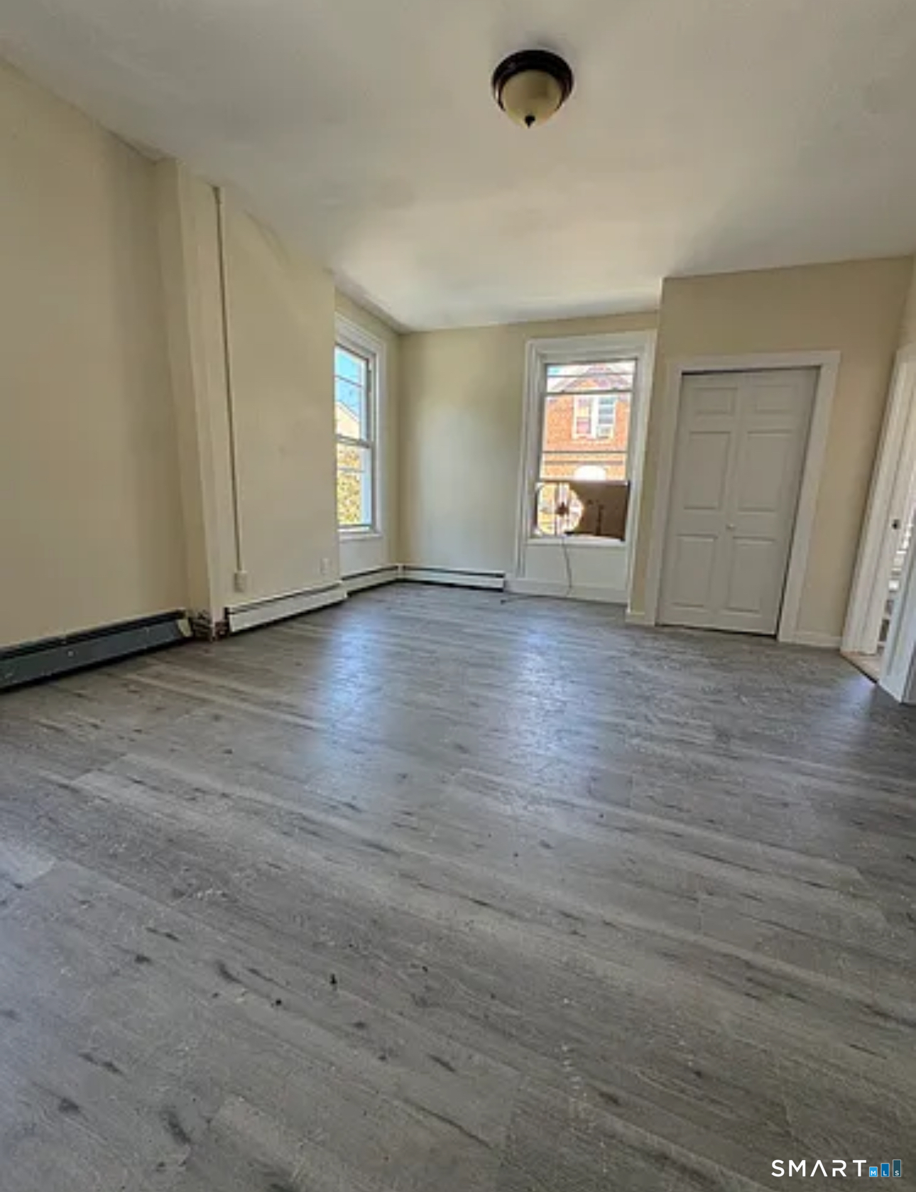 35 Cliff Street Norwich, CT 06360 - Photo 3 of 21 an empty room with wooden floor and window