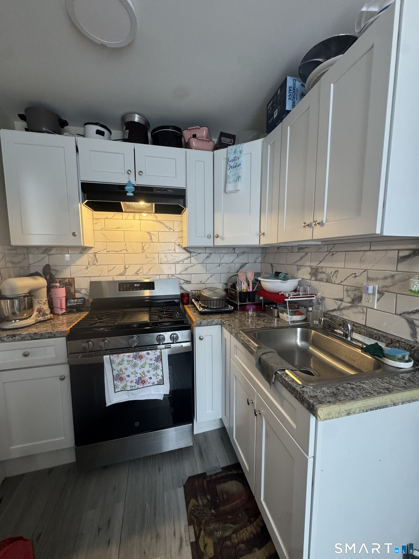 35 Cliff Street Norwich, CT 06360 - Photo 5 of 21 a kitchen with stainless steel appliances granite countertop a stove a sink and a microwave