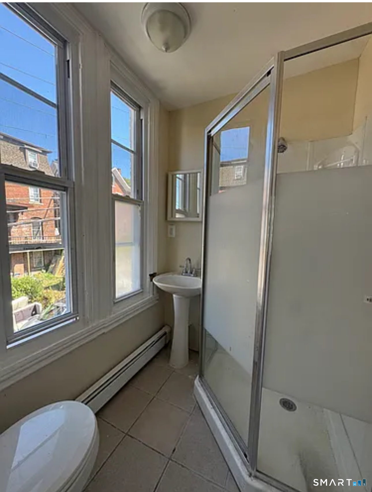 35 Cliff Street Norwich, CT 06360 - Photo 7 of 21 a bathroom with a toilet sink and a shower