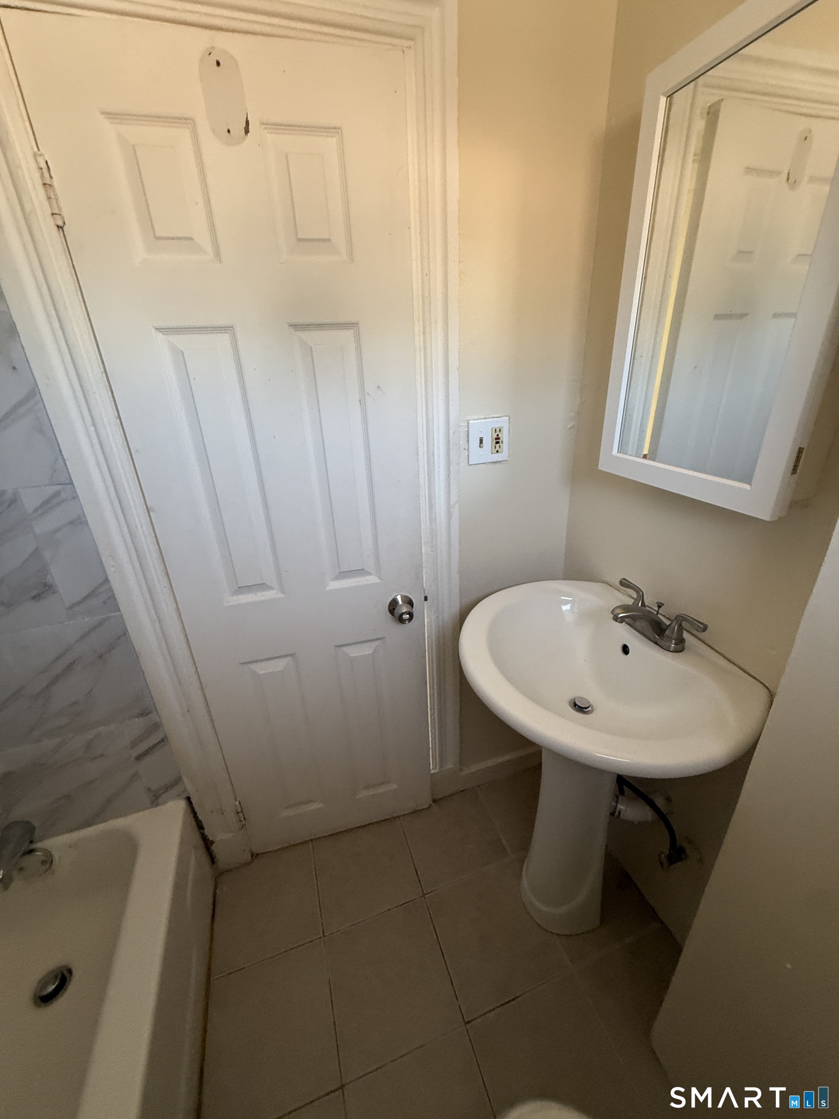 35 Cliff Street Norwich, CT 06360 - Photo 8 of 21 a bathroom with a sink a toilet and a mirror