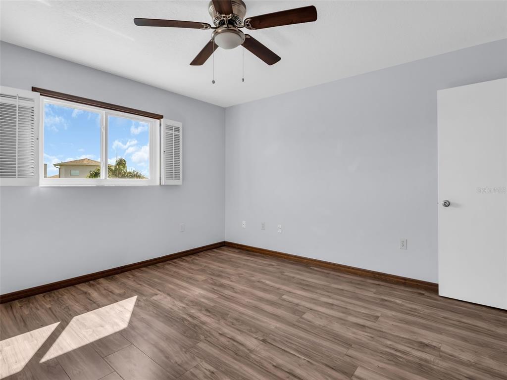 6241 Bayside Drive New Port Richey, FL 34652 - Photo 31 of 78 an empty room with wooden floor fan and windows
