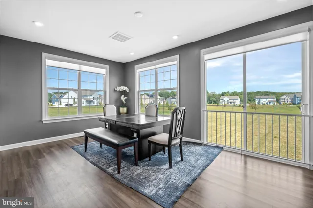 a view of a workspace with furniture and window