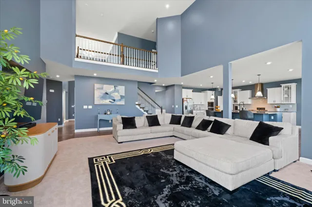 a living room with furniture a potted plant and a fireplace