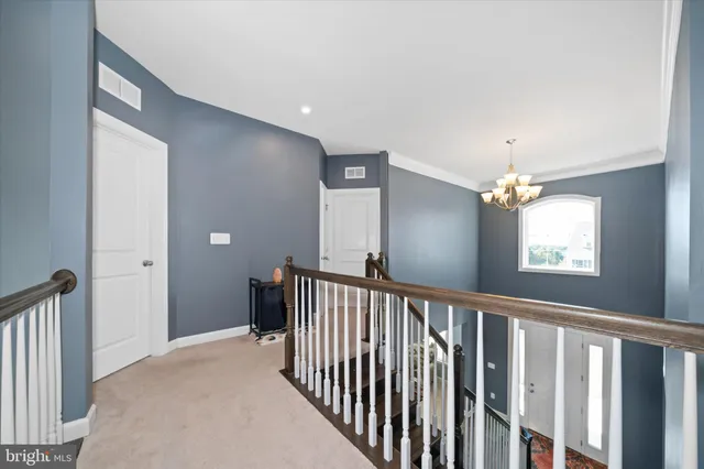 a view of a hallway with windows and stairs